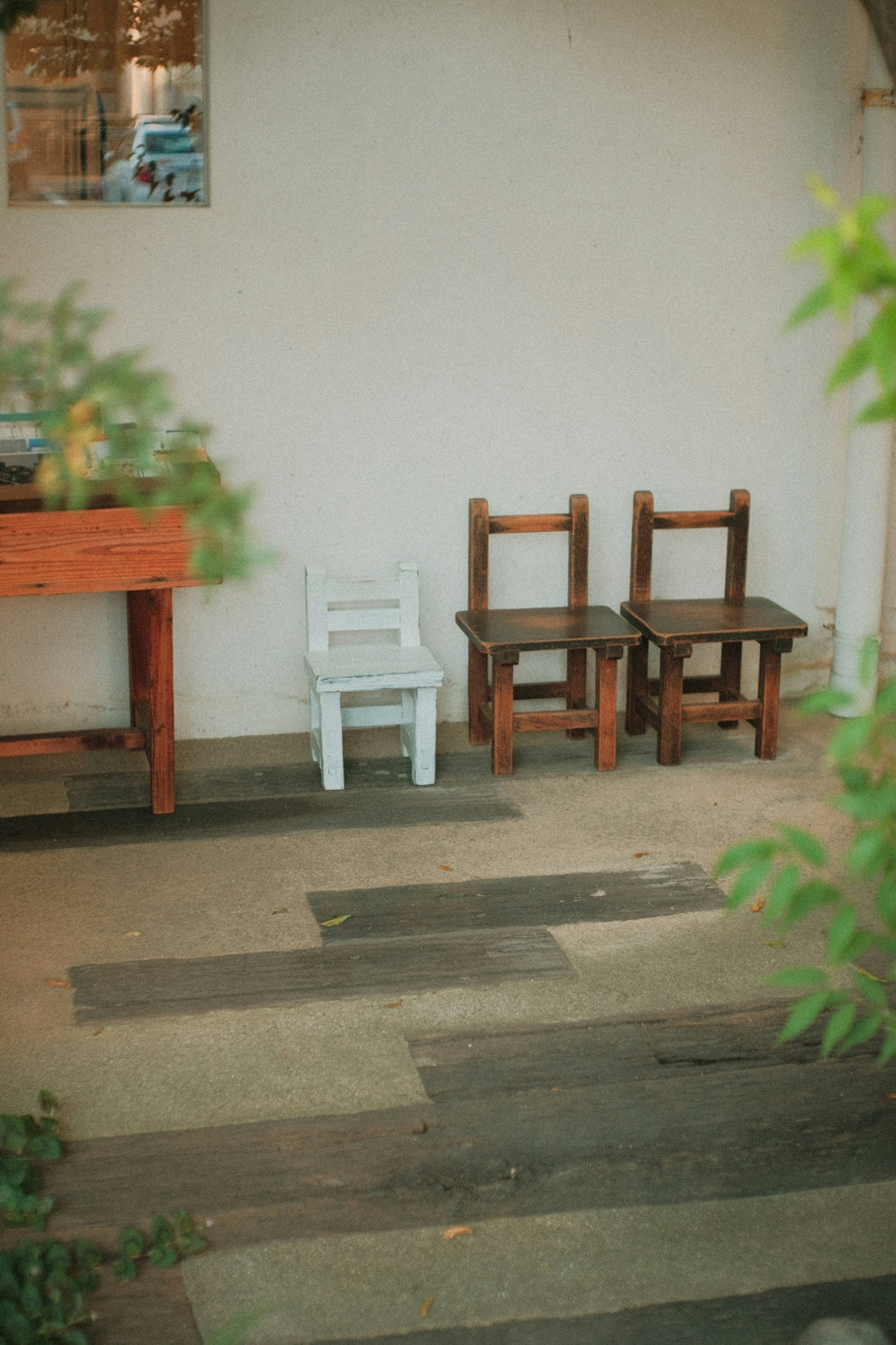 a couple of chairs sitting next to a wooden table