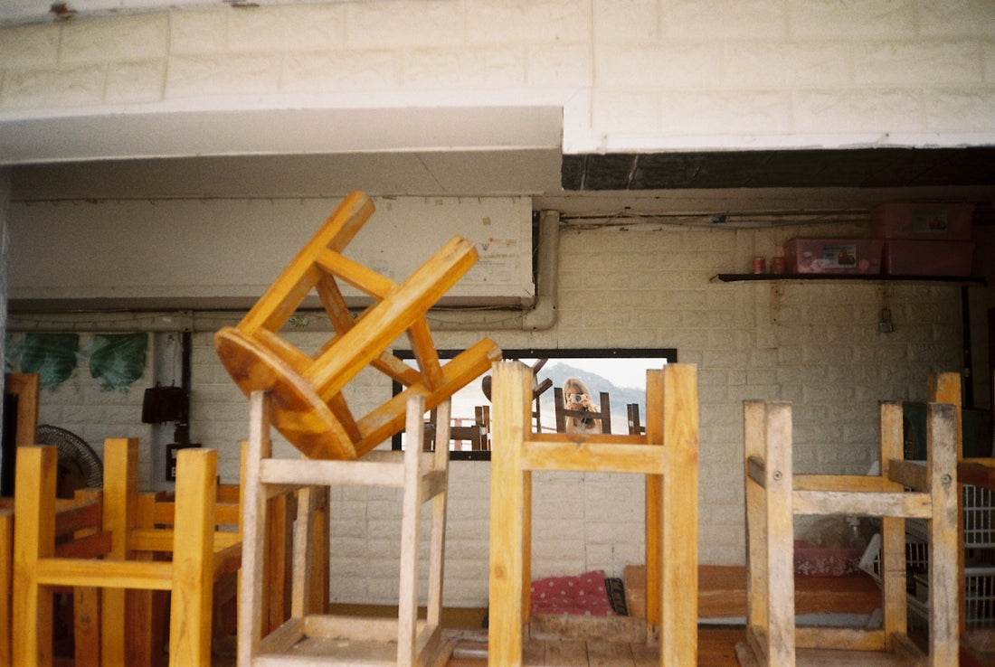 a room filled with lots of wooden chairs