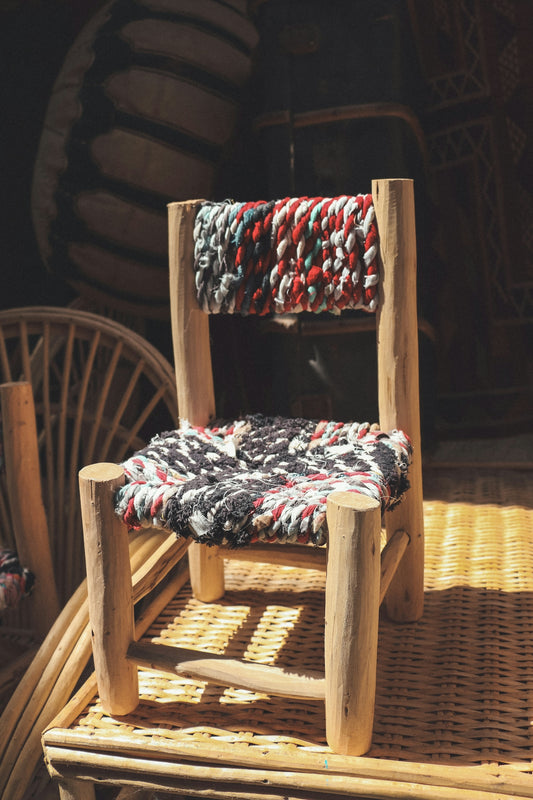 a chair made out of wood and rope
