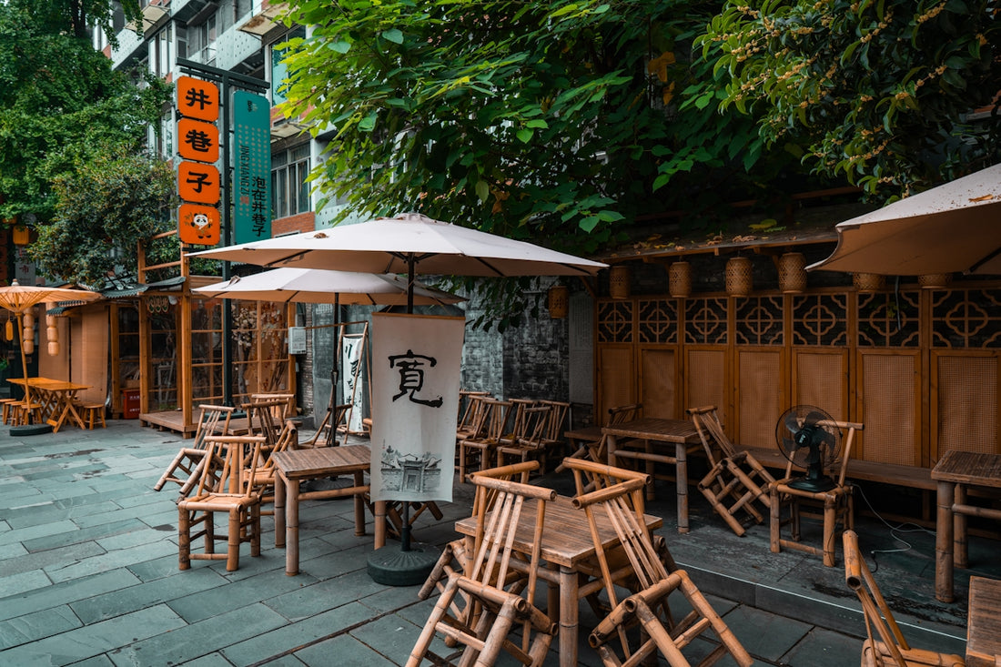 Outdoor cafe seating with wooden chairs and tables.